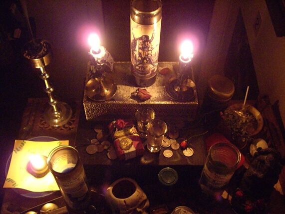 Amulet with burning candles and coins, good luck