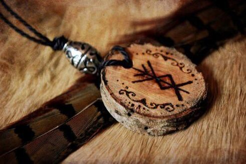 Pendant with runes as amulet of good luck